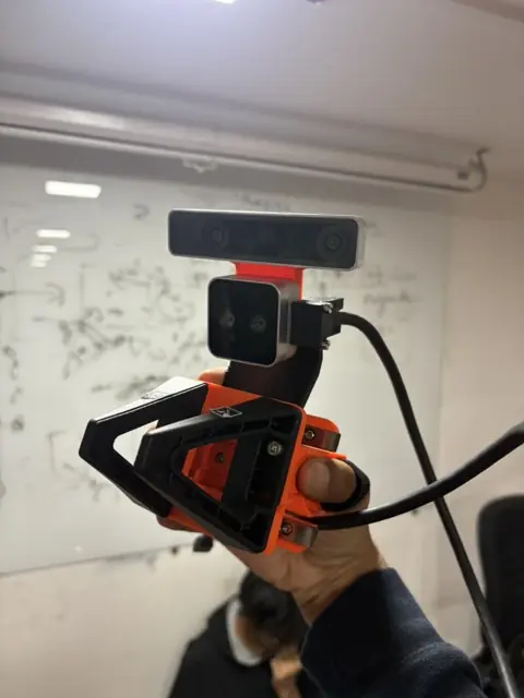 the handheld gripper, now with a tracking camera.